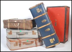 A collection of vintage 20th century steamer trunks and suitcases to include wooden bound steamer
