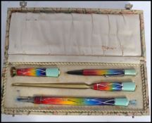 A stunning 20th century Art Deco writing set to include pencil, seal, paper knife and pen, in fitted