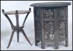 A 20th century Anglo Indian colonial foliate pierced and carved octagonal folding table made from