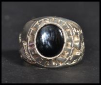 An unusual silver hallmarked oversized American Superbowl football ring having a central onyx