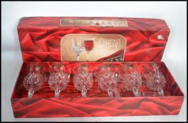 A boxed cased set of cut glass lead crystal wine glasses together with a lead glass decanter with