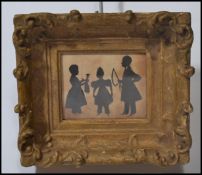 A 19th century Victorian silhouette cut out pictures depicting a group of three children playing