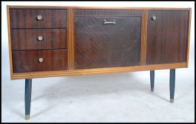 A  retro 20th century Danish influence teak wood sideboard raised on tapering legs with a series