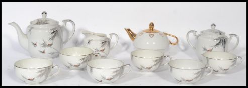 A vintage 20th century Japanese eggshell porcelain tea service, decorated with hand painted fauna