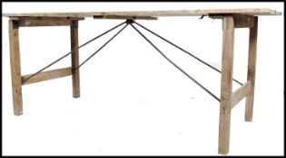 A vintage mid 20th century NAAFI dispersal folding table, plank top with square legs supported