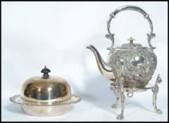 A late 19th century Victorian silver plated rococo spirit burner teapot, raised on stand with