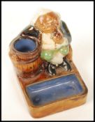 A Royal Doulton Lambeth, Harry Simeon, Gnome Smoking Match Holder, 8656 having a seated Gnome
