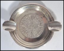 A silver ashtray of circular form, central Mayan d
