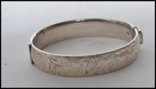 A silver hallmarked silver ingot pendant together with a silver hallmarked hinged bracelet.