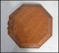 A Robert Thompson of Kilburn  ' Mouseman ' octagonal cheese board with trademark mouse on the