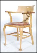 A vintage 20th century 1920's industrial oak office chair raised on pad feet with cabriole legs with
