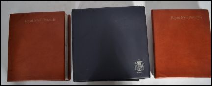 Philately; a collection of assorted First Day Covers and Royal Mail postcards. Spanning 3x albums.