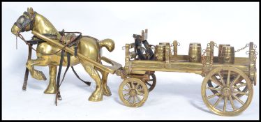 An early 20th century heavy cast brass figurine group of a horse and cart with miniature brass
