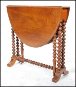 A 19th century Victorian walnut oval Sutherland table, moulded top, turned twin bobbin legs, ceramic