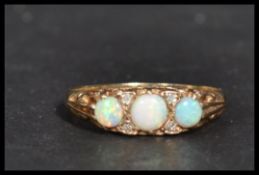 A hallmarked 9ct gold three stone opal dress ring.