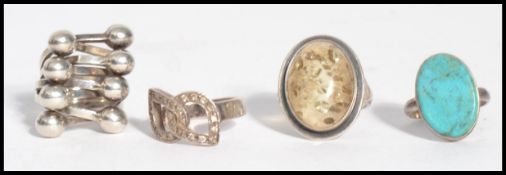 A group of four sterling silver dress rings to include a Danish inspired ring in the manner of