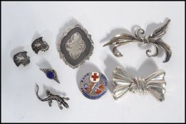 A group of vintage jewellery to include a silver flower / box brooch , another bow brooch , a Niello