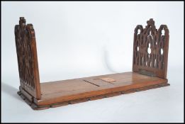 A 19th century mahogany ecclesiastical extending book stand trough on plinth  base with pierced