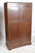 A 1930's oak Aw-Lyn double wardrobe compactum having oak full length qtr panel doors with
