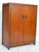 A 1930's Art Deco oak linen cupboard - cabinet having full length doors with shelved interior set