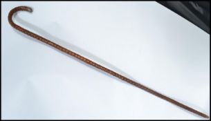 An early 20th century silver hallmarked mounted walking stick cane having a tapering a shaped