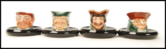 A group of four Royal Doulton character ashtrays, Old Charley, D5599 Parson Erown D5600 and two