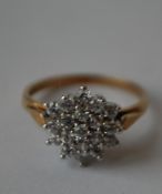A hallmarked 9ct gold cluster ring being set with round cut CZ.  Hallmarked London. Size O. Weight