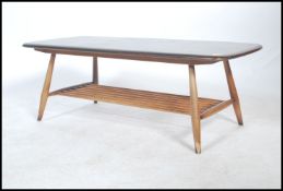 A vintage retro 20th century Ercol gold label low coffee table having a rail bottom raised on