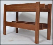A 1970's Danish teak wood retro magazine rack - canterbury by Guy Rogers. The panelled body with