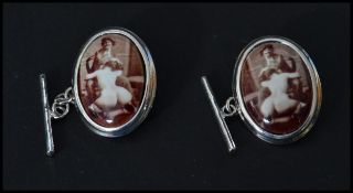 A pair of sterling silver and enamel cuff links depicting a nude erotic scene. Weighs 9 grams.