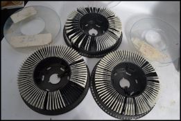 A large collection of 35mm colour transparency slides held within three plastic slide carousels