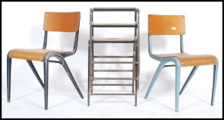A retro 1960's pair of French industrial stacking chairs having plywood seats and backrests along