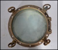 A good early 20th century heavy cast brass ships porthole of circular form. Measures 39cm.