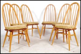 A set of 6 20th century Ercol beech and elm quaker pattern high back dining chairs. Raised on turned
