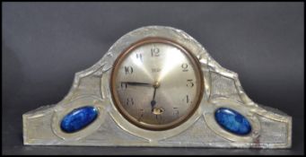 A Tudric pewter Art Nouveau mantle clock in the manner of Archibald Knox of Liberties. The clock