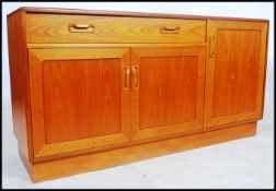 A 1970's retro teak wood sideboard by Ernest Gomme / G-Plan. In the Kelso pattern being raised on