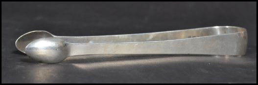 An early 19th century Georgian silver hallmarked pair of sugar tongs bearing hallmarks for London