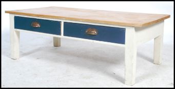 A 20th century shabby chic coffee table. Of rectangular form with drawers to the frieze having