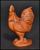 An Oriental Japanese netsuke carved in the form of a cockerel. Signed to base.