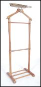 A vintage mid century light beech wood gentleman's valet stand having railed top and stretchers to