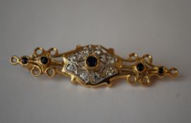 An 18ct gold blue sapphire and white stone brooch. Possibly Italian. Marked 750 tests 18ct gold.