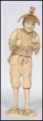 A 19th century Japanese Sectioned Ivory Okimono of a Merchant, Meiji period possibly of a musician