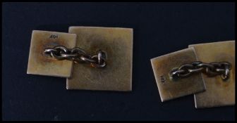 A pair of vintage early 20th century 14 carat gold cufflinks / cuffs of square form having an engine