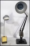 A 1940's Industrial pre-war Herbert Terry anglepoise lamp, raised on a cast metal two step base with