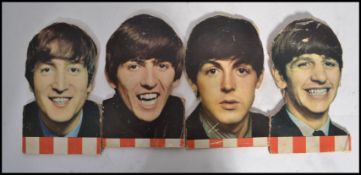 The Beatles - A set of four cut outs and mounted on wood possible shop advertising pieces of The