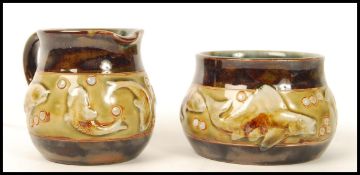A Royal Doulton stoneware creamer milk jug and sugar bowl, the design attributed to George Tinworth,