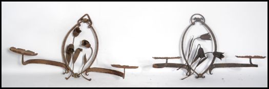 A pair of late 19th / early 20th century scroll work candle wall sconces constructed from wrought