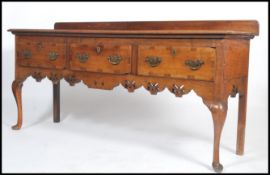 An 18th / 19th century oak dresser base being raised on cabriole legs with pointed hoof feet