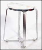 A vintage retro 20th century industrial chrome stool of tubular form having a white marble seat.