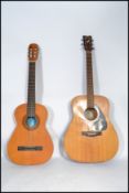 A vintage 20th century Yamaha F310 six string guitar along with a Clasico Spanish six string guitar.